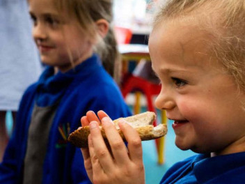 A girl smelling bread