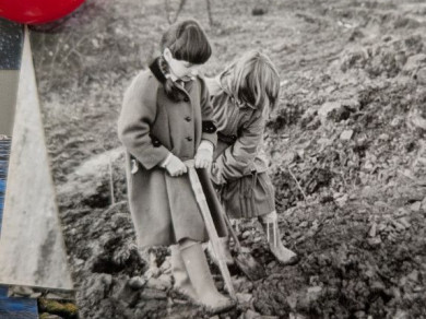 girl wearing coat digging