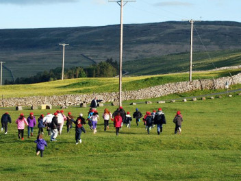 Children running up a hill