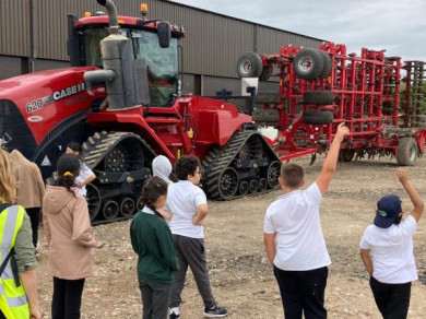 children standing in front of a tractor