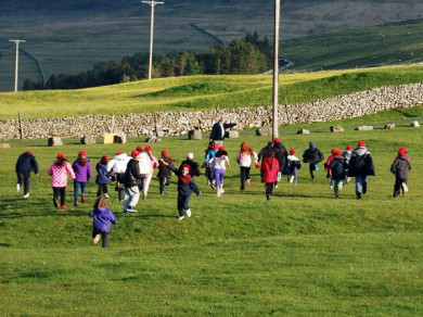 Children running up a hill