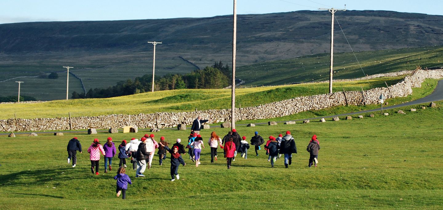 Children running up a hill