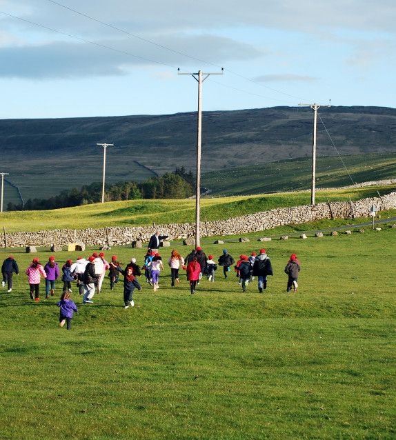 Children running up a hill