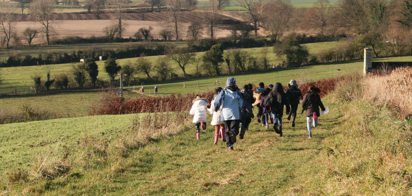 Children running along a field