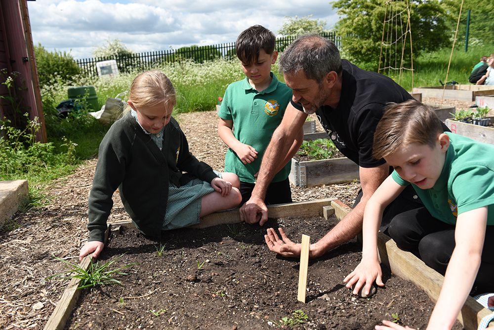 children looking and feeling the soil