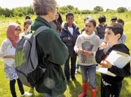 Coordinator teaching children in nature