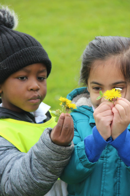 Boy and girl holding dandelions